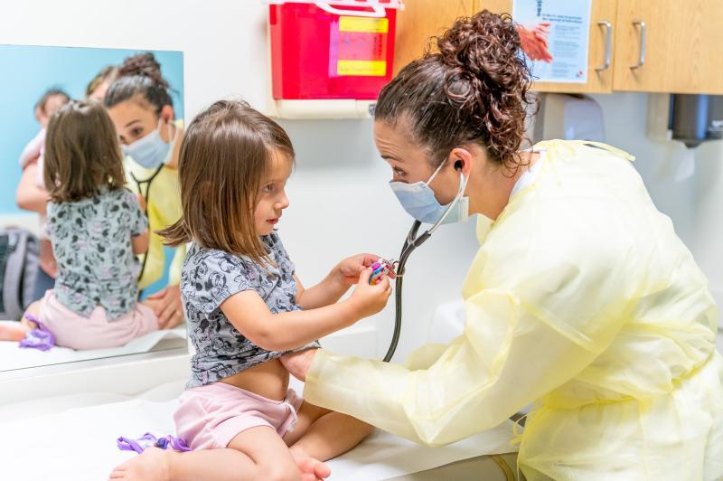 a girl getting examined by a doctor