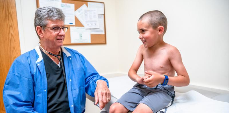 a doctor examining a young boy